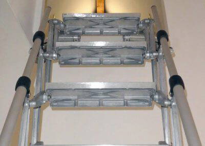 Elite Vertical heavy duty loft ladder extended from wall hatch. Premier Loft Ladders