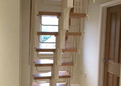 Compatta loft conversion stairs, featuring white powder coat steel structure. Premier Loft Ladders