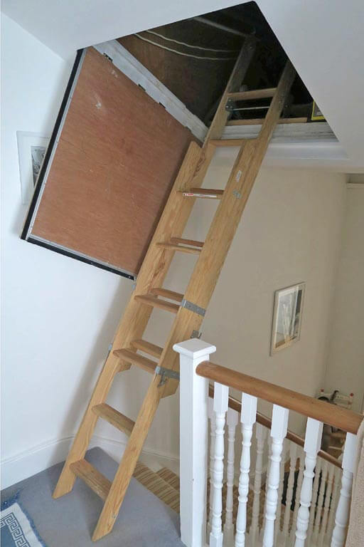 Sliding wooden loft ladder fitted into sloping loft hatch