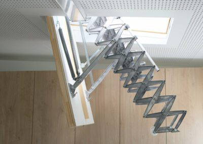 Sloped roof access hatch and retractable ladder.