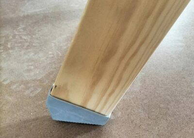 Timber loft ladder stile ends with non-slip plastic feet.