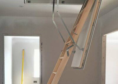 Designo timber loft ladder case study. 3-part folding ladder extended to floor.