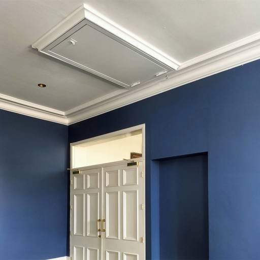 The fire-rated hatch was installed with decorative architrave and painted white to match the décor of the hall. The fire-rated hatch was installed with decorative architrave and painted white to match the décor of the hall.